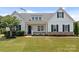 Charming single-Gathering home with a well-manicured lawn, front porch, and classic white siding at 152 Riverstone Dr, Davidson, NC 28036