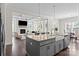Open-concept kitchen with island seating that offers views to the living room and dining area at 152 Riverstone Dr, Davidson, NC 28036