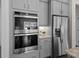 Close up of a modern kitchen featuring built in appliances and stainless steel refrigerator at 152 Riverstone Dr, Davidson, NC 28036