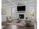 A beautiful living room featuring a fireplace, hardwood floors, coffered ceiling, and neutral decor at 152 Riverstone Dr, Davidson, NC 28036