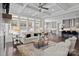 A spacious living room that opens to the kitchen features coffered ceilings, hardwood floors and fireplace at 152 Riverstone Dr, Davidson, NC 28036