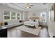 A spacious main bedroom suite features a tray ceiling, hardwood floors, and a cozy window bench at 152 Riverstone Dr, Davidson, NC 28036