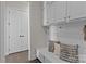 Mudroom featuring white shiplap, built-in bench with storage, and upper cabinets offering stylish organization at 152 Riverstone Dr, Davidson, NC 28036
