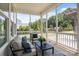 Relaxing screened porch with comfortable seating overlooking a well-maintained backyard at 152 Riverstone Dr, Davidson, NC 28036