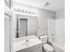 Well-lit bathroom with large mirror, white vanity, and a shower-tub combo at 1703 Southwind Dr, Charlotte, NC 28216