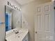 Well-lit bathroom featuring a sleek vanity, large mirror, and modern fixtures at 1703 Southwind Dr, Charlotte, NC 28216