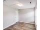 Neutral bedroom with wood floors, one window, a ceiling access panel and door at 1703 Southwind Dr, Charlotte, NC 28216