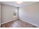 Bright bedroom with a window and wood-look flooring; perfect for relaxing at 1703 Southwind Dr, Charlotte, NC 28216