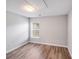 Neutral bedroom with wood floors, one window and a ceiling access panel at 1703 Southwind Dr, Charlotte, NC 28216