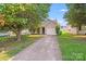 Charming home with a driveway and mature trees at 1703 Southwind Dr, Charlotte, NC 28216