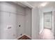 Functional laundry room with storage shelves and exterior access at 1703 Southwind Dr, Charlotte, NC 28216