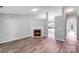 Spacious living room with fireplace and hardwood floors opens to the well-lit kitchen at 1703 Southwind Dr, Charlotte, NC 28216