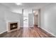 Open concept living room featuring a fireplace and hardwood floors with view to the kitchen at 1703 Southwind Dr, Charlotte, NC 28216