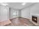 Inviting living room with light gray walls, wood-look flooring and cozy fireplace at 1703 Southwind Dr, Charlotte, NC 28216