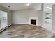 Inviting living room features a cozy fireplace, wood-look floors, and ample natural light streaming through the window at 1703 Southwind Dr, Charlotte, NC 28216