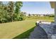Expansive backyard offering scenic views, complemented by a curved retaining wall with decorative flower pot at 17718 Terryglass Ln, Charlotte, NC 28278