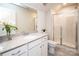Bright bathroom features a large vanity, framed mirror, and glass-enclosed shower for a spa-like feel at 17718 Terryglass Ln, Charlotte, NC 28278