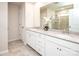 Bathroom featuring double sinks, quartz countertops, and a tiled shower, creating a spa-like atmosphere at 17718 Terryglass Ln, Charlotte, NC 28278
