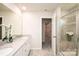 Elegant bathroom with double vanity, quartz countertops, and glass-enclosed shower with tiled walls at 17718 Terryglass Ln, Charlotte, NC 28278