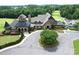 Stunning aerial view of a luxurious clubhouse with beautifully landscaped grounds and circular driveway at 17718 Terryglass Ln, Charlotte, NC 28278