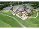 Aerial view showcases the clubhouse with a patio, outdoor seating, and manicured landscaping at 17718 Terryglass Ln, Charlotte, NC 28278