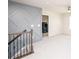 Hallway with staircase, railing, decorative accent wall, and laundry room at 17718 Terryglass Ln, Charlotte, NC 28278