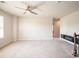 Neutral living room showcasing neutral walls and carpet, with a ceiling fan and fireplace at 17718 Terryglass Ln, Charlotte, NC 28278