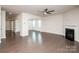 Expansive living room featuring dark hardwood floors, a modern fireplace, and abundant natural light at 17718 Terryglass Ln, Charlotte, NC 28278