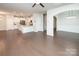 Open-concept living area with a view of the kitchen featuring granite countertops and stainless steel appliances at 17718 Terryglass Ln, Charlotte, NC 28278