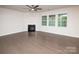 Bright living room featuring hardwood floors, a fireplace, and large windows providing plenty of natural light at 17718 Terryglass Ln, Charlotte, NC 28278