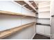 Spacious pantry with rustic wooden shelving and white cabinets, maximizing storage in this organized space at 17718 Terryglass Ln, Charlotte, NC 28278