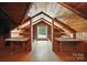 Unfinished attic featuring wood beams and an abundance of natural light, offering a unique space at 188 Gum Branch Rd # 3, Charlotte, NC 28214
