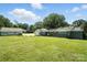Spacious backyard featuring a charming gray home with a sunroom addition and a detached garage at 188 Gum Branch Rd # 3, Charlotte, NC 28214