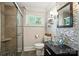 Stylish bathroom with a glass shower door, mosaic tile accent wall, and a modern vessel sink at 188 Gum Branch Rd # 3, Charlotte, NC 28214