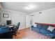 Well-lit bedroom featuring modern gray walls, an open doorway, and a comfortable blue sofa at 188 Gum Branch Rd # 3, Charlotte, NC 28214