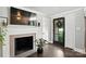 Stylish entryway featuring a stone fireplace, a mounted TV, and a glass-paneled door at 188 Gum Branch Rd # 3, Charlotte, NC 28214