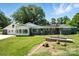 Charming home with a gray exterior, white trim, sunroom, and a well-manicured lawn at 188 Gum Branch Rd # 3, Charlotte, NC 28214