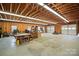 Spacious garage with bare wooden trusses, concrete flooring, and ample storage space at 188 Gum Branch Rd # 3, Charlotte, NC 28214