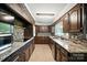 Galley kitchen features granite counters, mosaic backsplash, stainless appliances and painted brick oven surround at 188 Gum Branch Rd # 3, Charlotte, NC 28214
