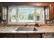 Kitchen sink area featuring granite countertops, and a mosaic tile backsplash at 188 Gum Branch Rd # 3, Charlotte, NC 28214