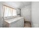 Bright laundry room with white appliances, neutral walls, and a window for natural light at 188 Gum Branch Rd # 3, Charlotte, NC 28214