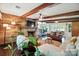 Cozy living room featuring a brick fireplace, exposed beams, hardwood floors, and comfortable seating at 188 Gum Branch Rd # 3, Charlotte, NC 28214