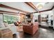 Open living room with exposed beams, a brick fireplace, hardwood floors, and comfortable furniture at 188 Gum Branch Rd # 3, Charlotte, NC 28214