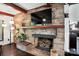 Living room with stone fireplace, brick surround, mantle, and decorative hearth at 188 Gum Branch Rd # 3, Charlotte, NC 28214