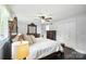 Bright main bedroom features dark wood floors, king size bed and modern ceiling fan at 188 Gum Branch Rd # 3, Charlotte, NC 28214