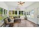 Bright sunroom with large windows, ceiling fan, and a comfortable sectional sofa at 188 Gum Branch Rd # 3, Charlotte, NC 28214