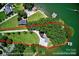 Aerial view showcasing the home's wooded lot and private waterfront access, approximately 300' shoreline at 188 Ponderosa Cir, Mooresville, NC 28117