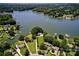 Stunning aerial view of lakefront home with lush landscaping and private dock, approximately 300' shoreline at 188 Ponderosa Cir, Mooresville, NC 28117