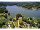 Stunning aerial view of lakefront home with lush landscaping and private dock, approximately 300' shoreline at 188 Ponderosa Cir, Mooresville, NC 28117