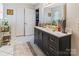 Modern bathroom featuring stylish vanity with gold fixtures, a large mirror, and tiled floors at 188 Ponderosa Cir, Mooresville, NC 28117
